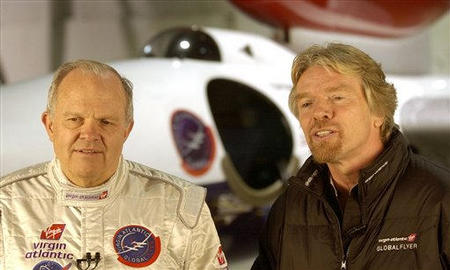 Pilot Steve Fossett, left, and Sir Richard Branson, stand in front of the GlobalFlyer as they give television interviews in a hanger at the Salina Municipal Airport in Salina, Kansas, February 28, 2005.